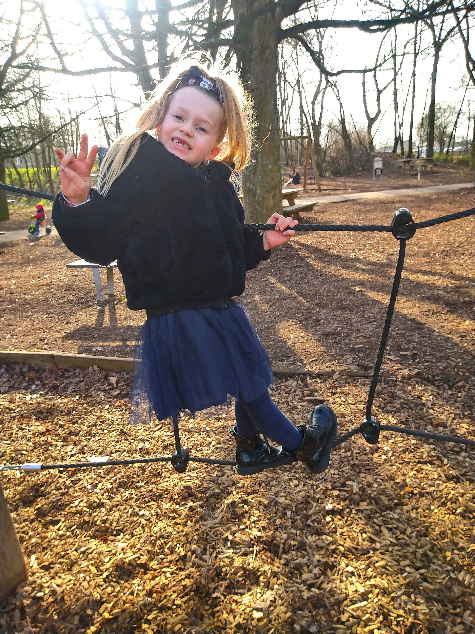 Lucie participe au concours pour gagner de l'argent avec cette photo : branch, electric_blue, fun, grass, happy, leisure, people_in_nature, person, playground, recreation, sitting, sky, smile, soil, swing, tints_and_shades, toddler, tree, winter, wood