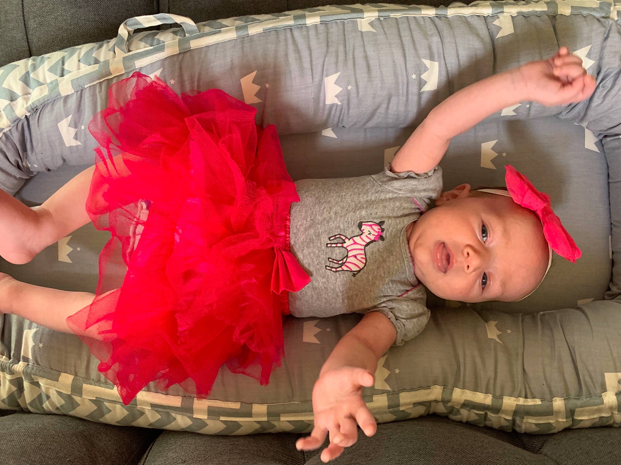 Mirabella is registered to the contest to win money with this photo: baby, baby_toddler_clothing, child, comfort, couch, fashion, finger, fun, human_body, human_leg, lap, leg, mouth, person, pink, skin, textile, thigh, toddler, trunk