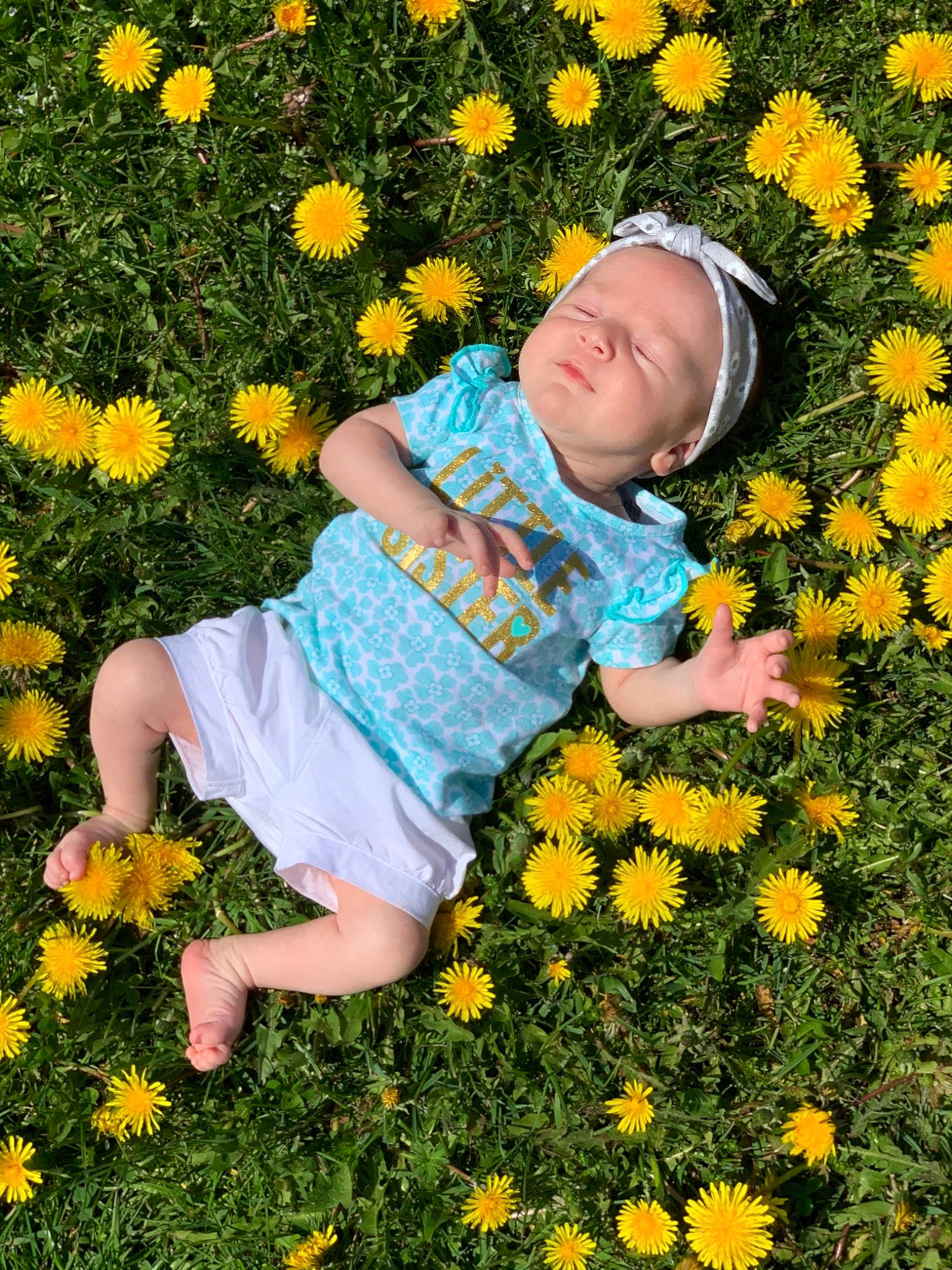 Mirabella is registered to the contest to win money with this photo: baby_toddler_clothing, botany, facial_expression, flower, flowering_plant, fun, grass, green, groundcover, happy, leaf, meadow, nature, orange, people_in_nature, person, petal, photograph, plant, toddler