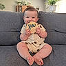 Leo joined the competition — help win amazing prizes! baby, child, smiling, couch, indoor, plaque, wooden, plant, chandelier, curtains, window, home, furniture, infant, happy, person, portrait, sitting, clothing, cute