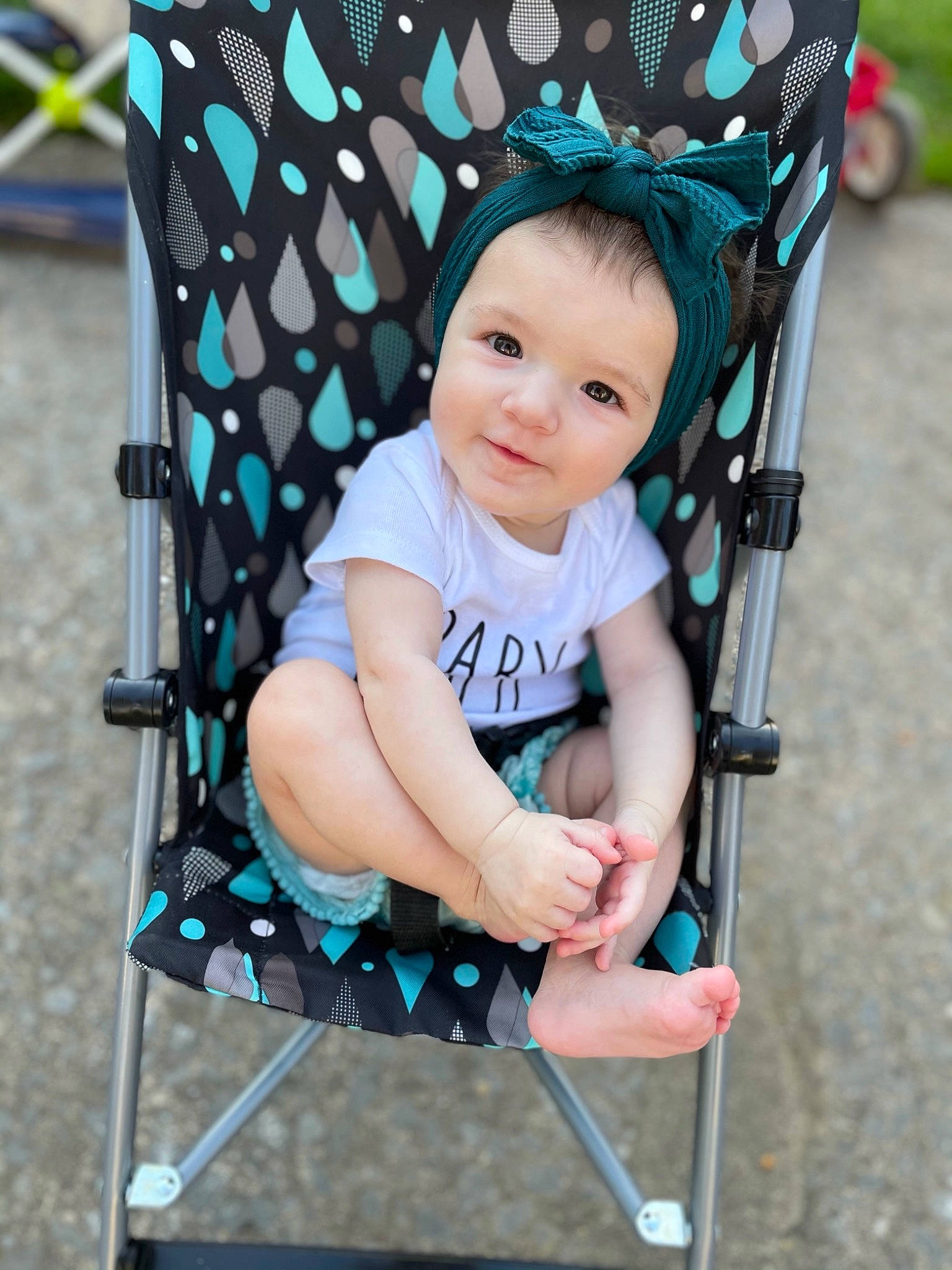 Dalia is registered to the contest to win money with this photo: arm, baby, baby_carriage, baby_products, baby_toddler_clothing, beauty, black, child, comfort, electric_blue, eye, green, happy, head, headwear, leisure, people, person, public_space, skin
