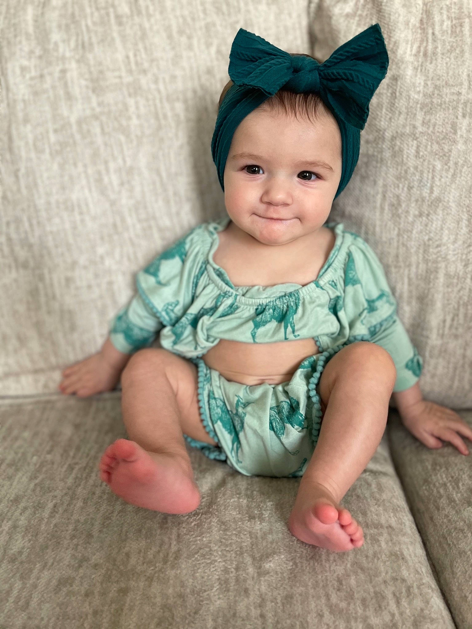 Dalia is registered to the contest to win money with this photo: baby, baby_toddler_clothing, cap, cheek, child, costume_hat, dress, eye, face, happy, head, iris, joy, pattern, person, pink, sitting, skin, sleeve, textile