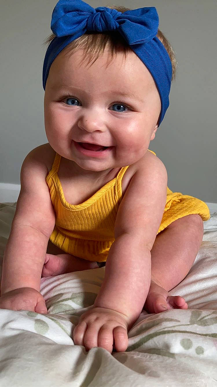 Alora is registered to the contest to win money with this photo: baby, baby_toddler_clothing, blue, cap, cheek, chin, eye, eyebrow, finger, happy, head, iris, joy, lip, mouth, nose, person, pink, skin, smile