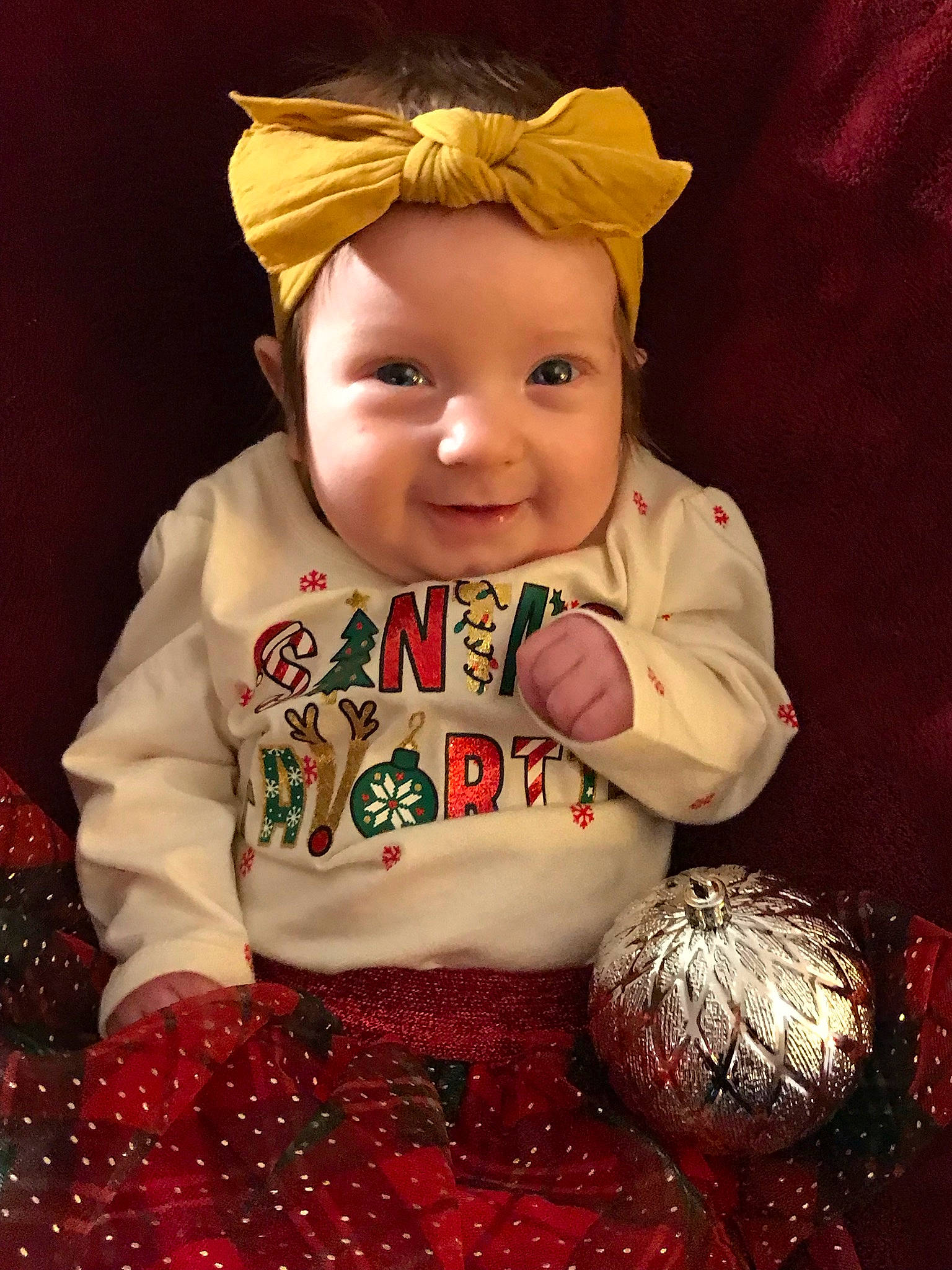 Peyton is registered to the contest to win money with this photo: baby, baby_toddler_clothing, carmine, child, christmas, christmas_decoration, christmas_eve, christmas_ornament, costume_hat, event, fictional_character, happy, headwear, holiday, holiday_ornament, joy, ornament, pattern, person, santa_claus