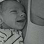 Elio participe au concours pour gagner de l'argent avec cette photo : baby, black_and_white, close_up, comfort, cute, fabric, face, happy, infant, joy, love, newborn, person, portrait, skin, smile, striped_clothing, tank_top, tenderness, texture