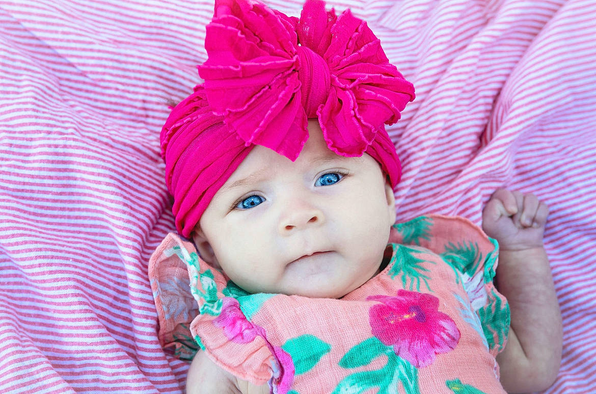 Brinley joined the competition — help win amazing prizes! baby, baby_products, baby_toddler_clothing, cap, child, eyelash, fashion_accessory, grass, hair_accessory, happy, headgear, headwear, knit_cap, linens, lip, magenta, pattern, person, pink, purple