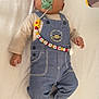 Malick a rejoint le concours — aidez-le/la à gagner de superbes lots ! baby, baby_accessories, blanket, child, clothing, colorful, curious, cute, denim_overalls, face, indoor, infant, long_sleeve_shirt, lying_down, pacifier, playful, socks, soft, toy, young_child