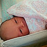 Bonnie is registered to the contest to win money with this photo: newborn, baby, blanket, bassinet, mesh, hand, sleepy, face, infant, pattern, pink, white, cozy, wrapped, bed, soft, closeup, cute, resting, indoors