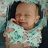 baby, sleeping, blanket, butterfly_pattern, swaddled, newborn, infant, peaceful, smile, closeup, portrait, soft_light, cozy, cute, child, wrapped, texture, fabric, head, face