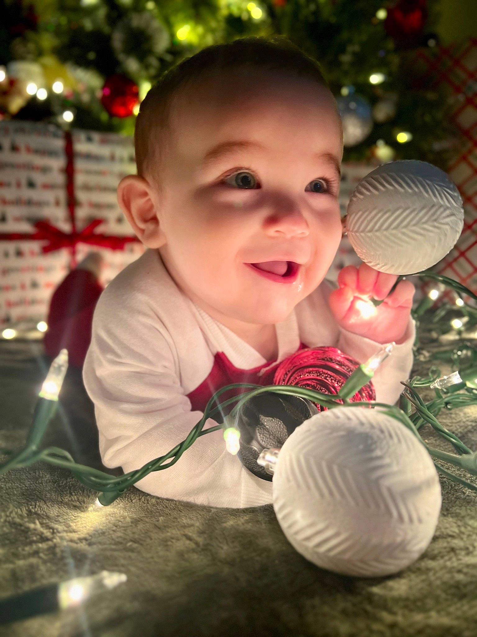 Lennox is registered to the contest to win money with this photo: baby, beauty, child, christmas, christmas_decoration, christmas_ornament, event, flash_photography, fun, grass, happy, holiday, nature, ornament, people_in_nature, person, plant, smile, toddler, tree