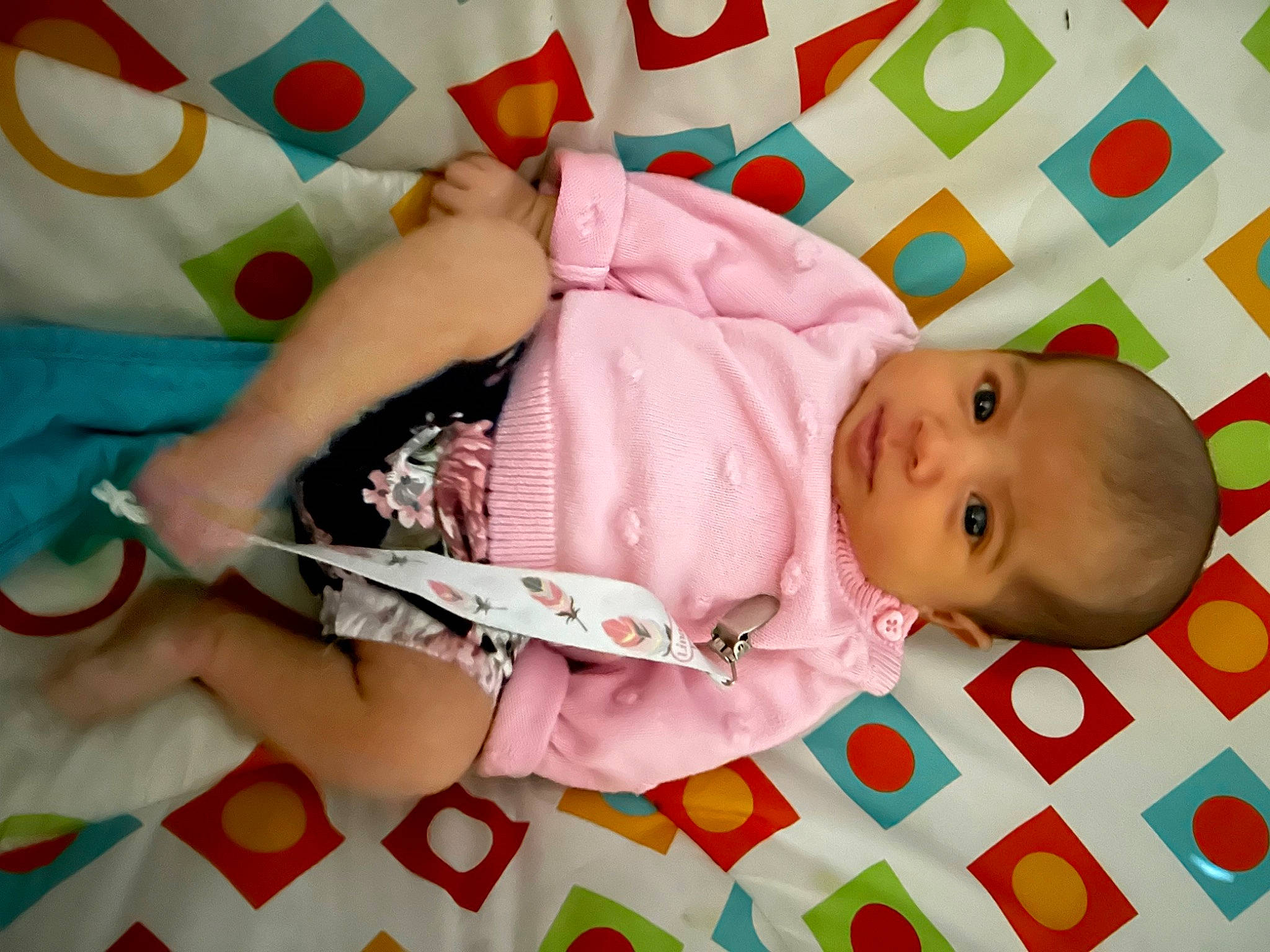 Frances is registered to the contest to win money with this photo: baby, baby_products, baby_safety, baby_toddler_clothing, cheek, child, comfort, linens, pattern, person, pink, room, skin, sleeve, toddler