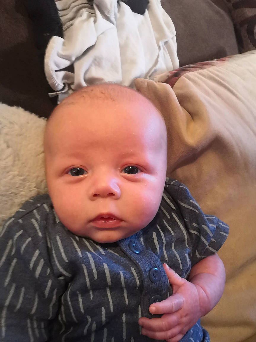 John is registered to the contest to win money with this photo: baby, cheek, child, eye, face, finger, hand, head, lip, nose, person, skin, smile, thumb, toddler