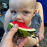 Alex is registered to the contest to win money with this photo: toddler, child, watermelon, fruit, bite, hand, blue_eyes, outdoor, summer, food, person, skin, casual, lap, short_sleeve, bracelet, face, close_up, eating, happy