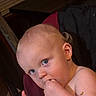 baby, child, blue_eyes, fingers, indoor, curious, skin, hair, face, expression, eating, snack, hand, portrait, person, light, shadow, closeup, infant, young