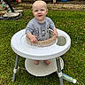 baby, child, walker, grass, outdoor, porch, chair, baby_bottle, shirt, smile, face, foot, toy, person, greenery, yard, playtime, happy, cute, casual