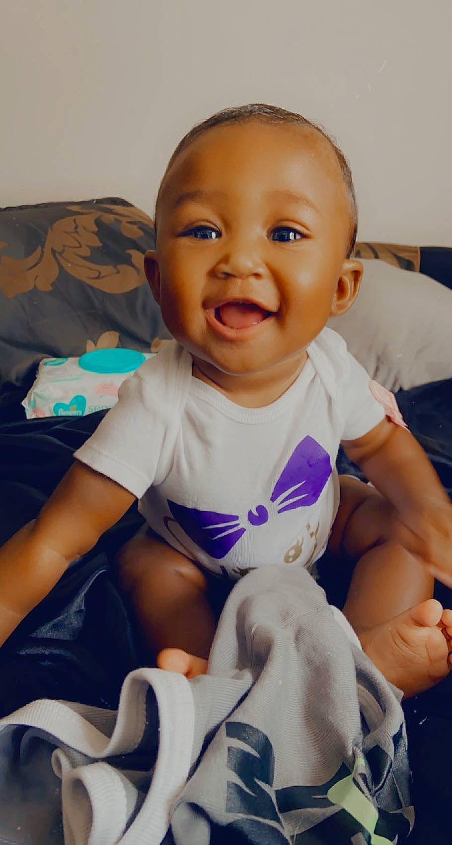 Anaiyah joined the competition — help win amazing prizes! abdomen, arm, baby, baby_toddler_clothing, blue, cheek, child, comfort, electric_blue, fun, happy, knee, mouth, person, purple, skin, sleeve, smile, t_shirt, thigh
