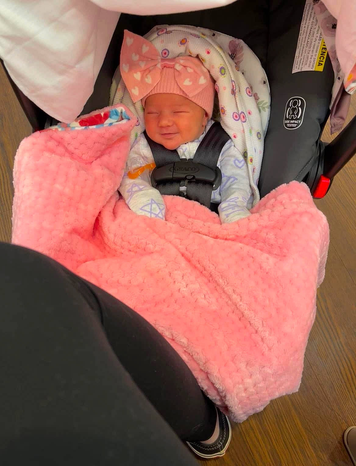 Rosalie joined the competition — help win amazing prizes! baby, baby_carriage, baby_products, baby_toddler_clothing, car_seat, carmine, cheek, child, comfort, eye, face, flooring, head, headwear, magenta, person, pink, recreation, sitting, sleeve