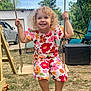 child, swing, outdoor, smiling, curly_hair, flower_pattern, playground, summer, happy, grass, tree, car, shoes, daylight, nature, garden, person, joyful, clothing, seat