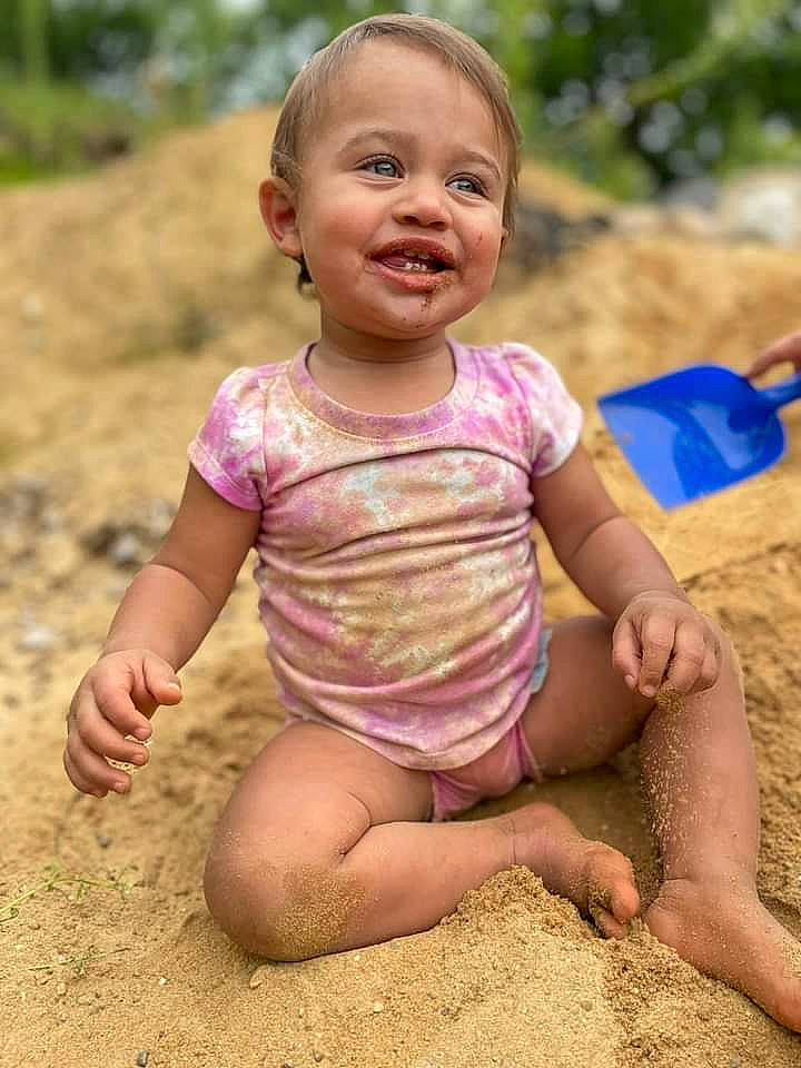 Xandria joined the competition — help win amazing prizes! baby_toddler_clothing, child, face, finger, fun, grass, happy, joy, leisure, mud, people_in_nature, person, plant, play, recreation, sand, sitting, sleeve, smile, soil