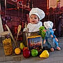 Augustine participe au concours pour gagner de l'argent avec cette photo : apple, baby, blue_rat, chef_hat, child, cooking_pot, costume, cute, floor, fruit, grapes, indoor, kitchen_backdrop, orange, pasta, pear, playful, plush_toy, portrait, wooden_spoons