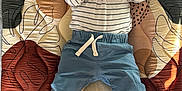 Isaiah is registered to the contest to win money with this photo: baby, child, bottle, milk, striped_shirt, blue_pants, barefoot, mat, patterned_mat, indoor, cute, lying_down, hands, feet, infant, portrait, casual_clothing, natural_light, relaxed, young