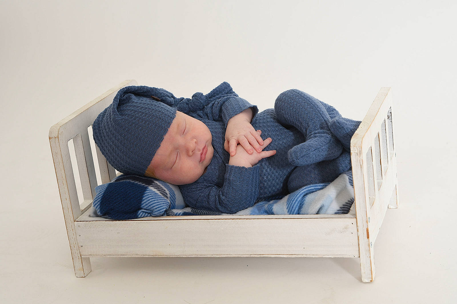 Emilio is registered to the contest to win money with this photo: arm, baby, baby_products, baby_sleeping, baby_toddler_clothing, comfort, denim, electric_blue, hand, headwear, human_body, infant_bed, leg, leisure, linens, outdoor_furniture, person, rectangle, sitting, sleeve
