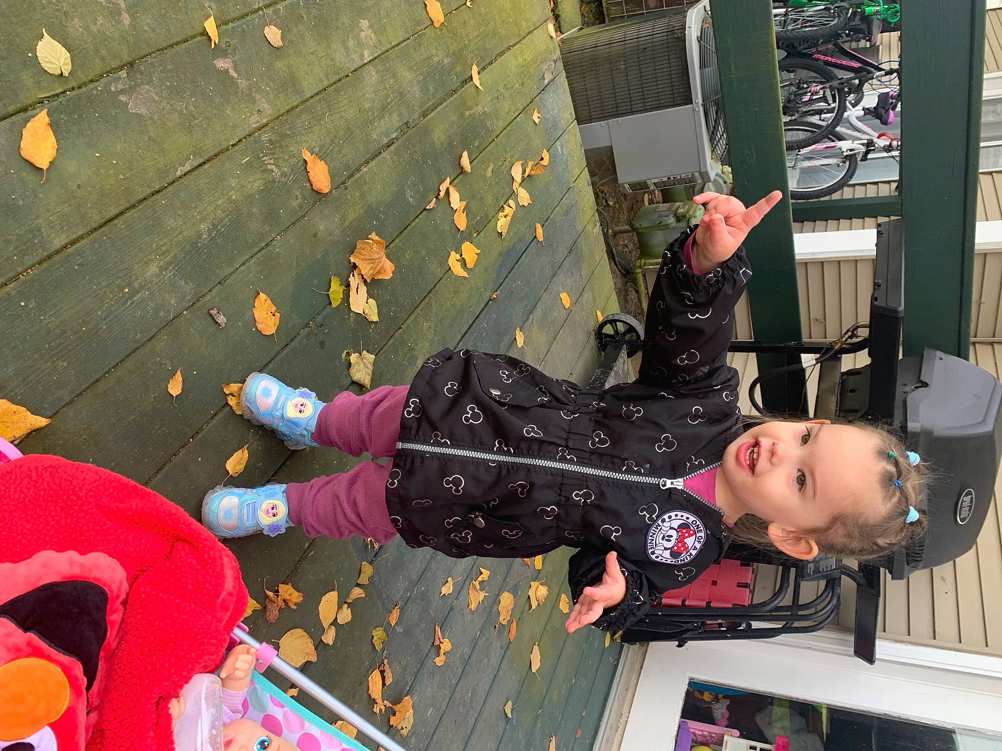 Evelyn is registered to the contest to win money with this photo: bicycle_wheel, boot, child, costume, design, flooring, fun, human_leg, leisure, luggage_and_bags, pattern, person, photograph, recreation, room, shoe, snapshot, thigh, tire, tree