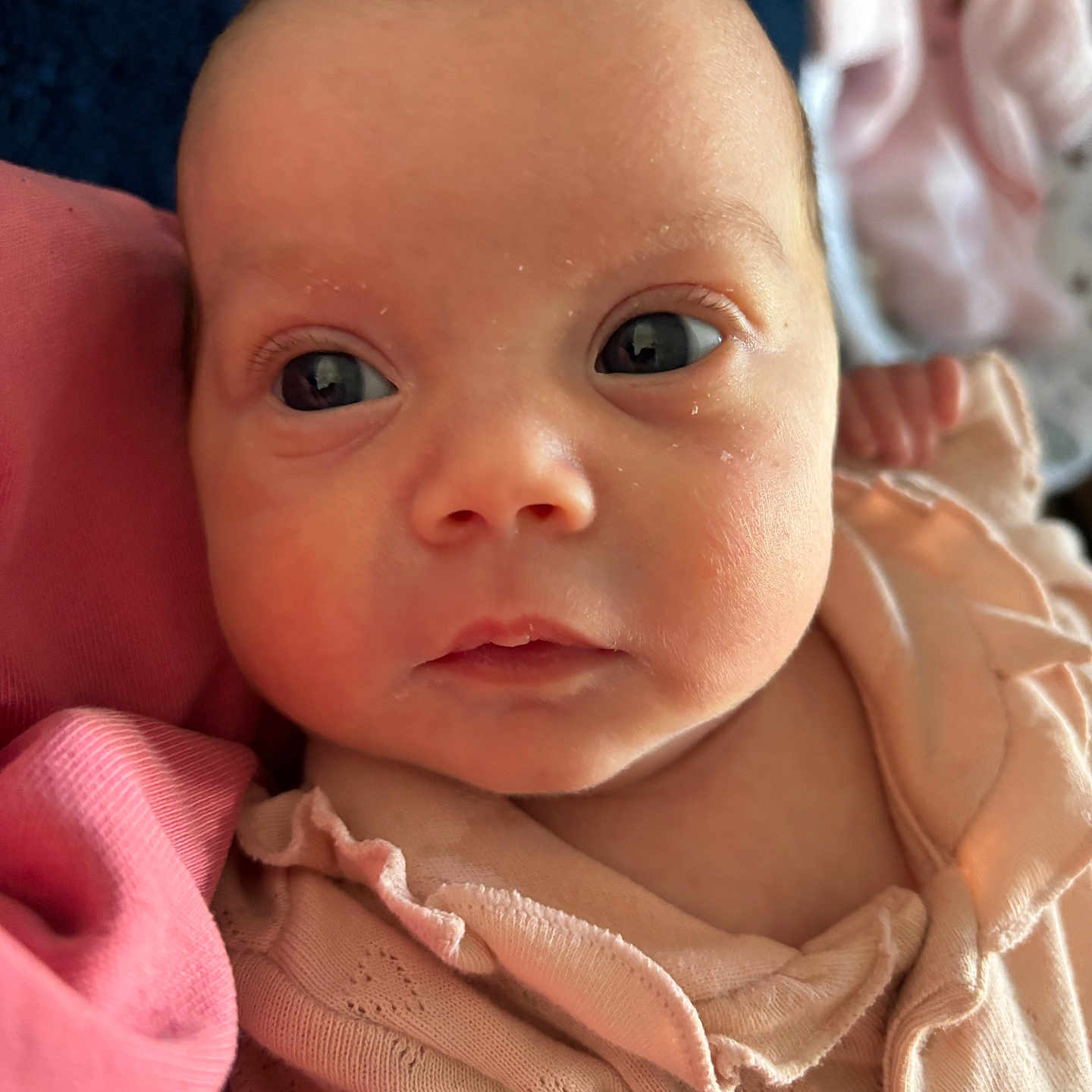 Stevie is registered to the contest to win money with this photo: baby, child, closeup, clothing, cute, expression, eyes, fabric, face, indoors, infant, newborn, person, pink, portrait, resting, ruffles, skin, soft, young