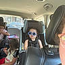 Sage joined the competition — help win amazing prizes! backseat, car, car_seat, casual, child, children, cute, family, glasses, hair, interior, person, seat, seatbelt, snack, sunglasses, travel, vehicle, window, young
