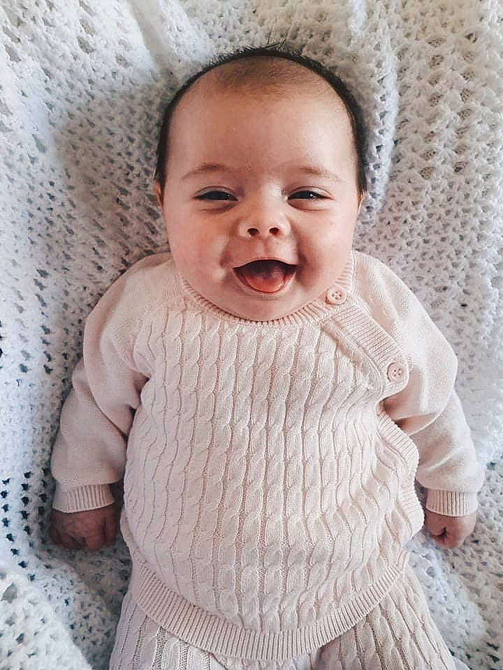 Harriet is registered to the contest to win money with this photo: baby, baby_laughing, cheek, child, face, facial_expression, head, knitting, laugh, lip, mouth, nose, outerwear, pattern, person, photograph, photography, skin, smile, toddler
