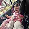 toddler, child, car_seat, pink_ribbons, rain, car_window, headband, pink_clothing, seatbelt, indoors, raindrops, cute, baby, car_interior, child_safety, curious, soft_blanket, casual_clothing, portrait, young_child
