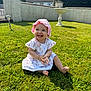 baby, child, smiling, grass, outdoor, sunlight, pink_hat, white_dress, happy, clapping, garden, nature, summer, cute, sitting, footwearless, greenery, daytime, wall, residential