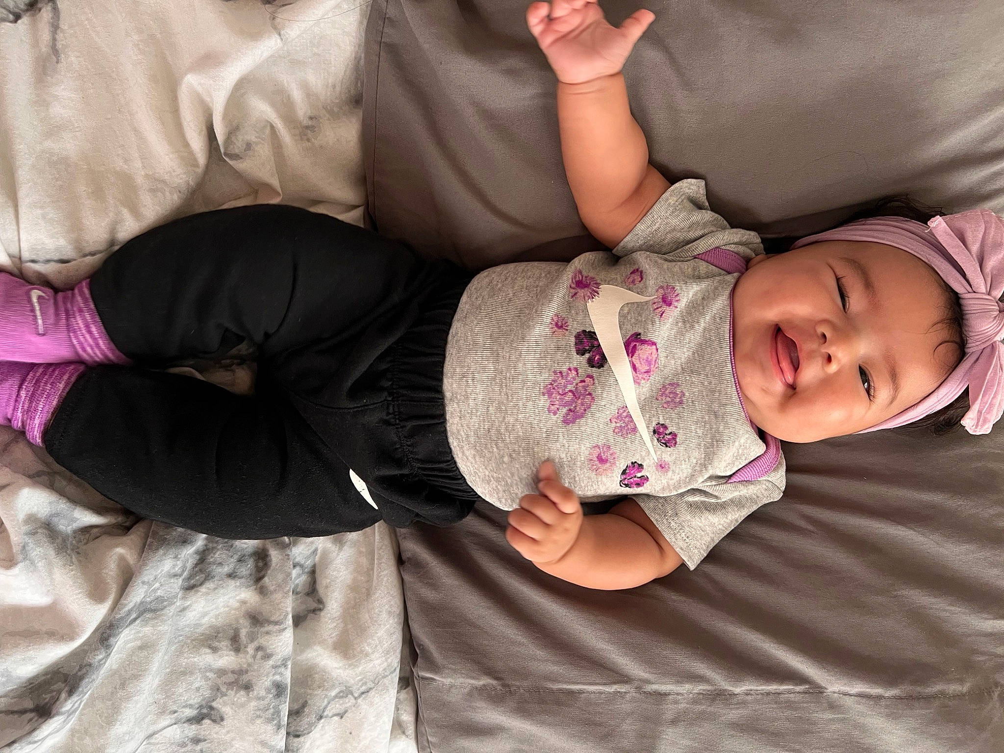 Adalynn is registered to the contest to win money with this photo: baby, baby_toddler_clothing, cheek, child, comfort, elbow, gesture, happy, headwear, human_body, human_leg, nose, person, pink, purple, sitting, skin, sleeve, textile, thigh