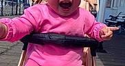 Tallulah joined the competition — help win amazing prizes! architecture, baby, building, chair, city, clothing, coat, face, furniture, happy, head, jacket, outdoors, person, photography, portrait, road, shelter, street, urban