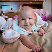 Lyla is registered to the contest to win money with this photo: baby, bed, bedroom, blanket, bodypart, couch, face, finger, furniture, hand, happy, head, homedecor, indoors, newborn, person, photography, portrait, room, smile