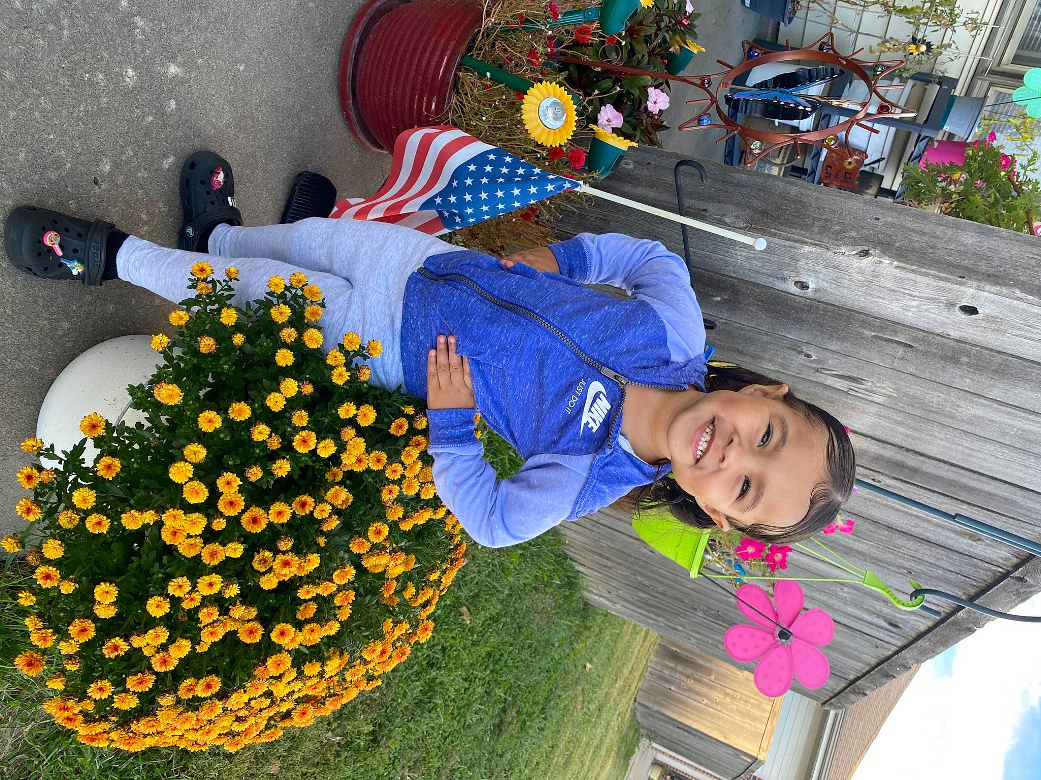 Nevaeh is registered to the contest to win money with this photo: annual_plant, child, event, floral_design, flower, flower_arranging, fun, garden, grass, green, happy, hat, joy, leisure, orange, people_in_nature, person, petal, plant, smile