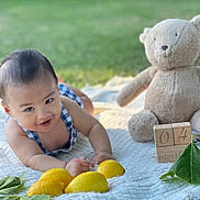Sardonyx Elijah joined the competition — help win amazing prizes! baby, smiling, outdoor, blanket, lemon, toy, teddy_bear, wooden_block, green_leaf, grass, child, four_months, cute, infant, summer, nature, playful, portrait, happy, clothing