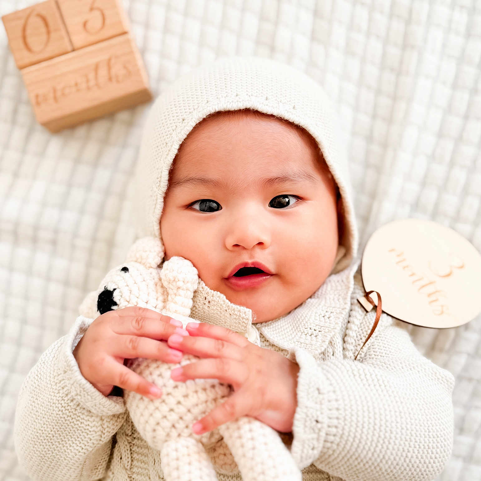 Sardonyx Elijah is registered to the contest to win money with this photo: 3_months, baby, blanket, bonnet, child, cozy, crocheted_toy, cute, face, hands, indoor, infant, knit_clothing, lying_down, newborn, portrait, soft_texture, teddy_bear, warm, wooden_blocks