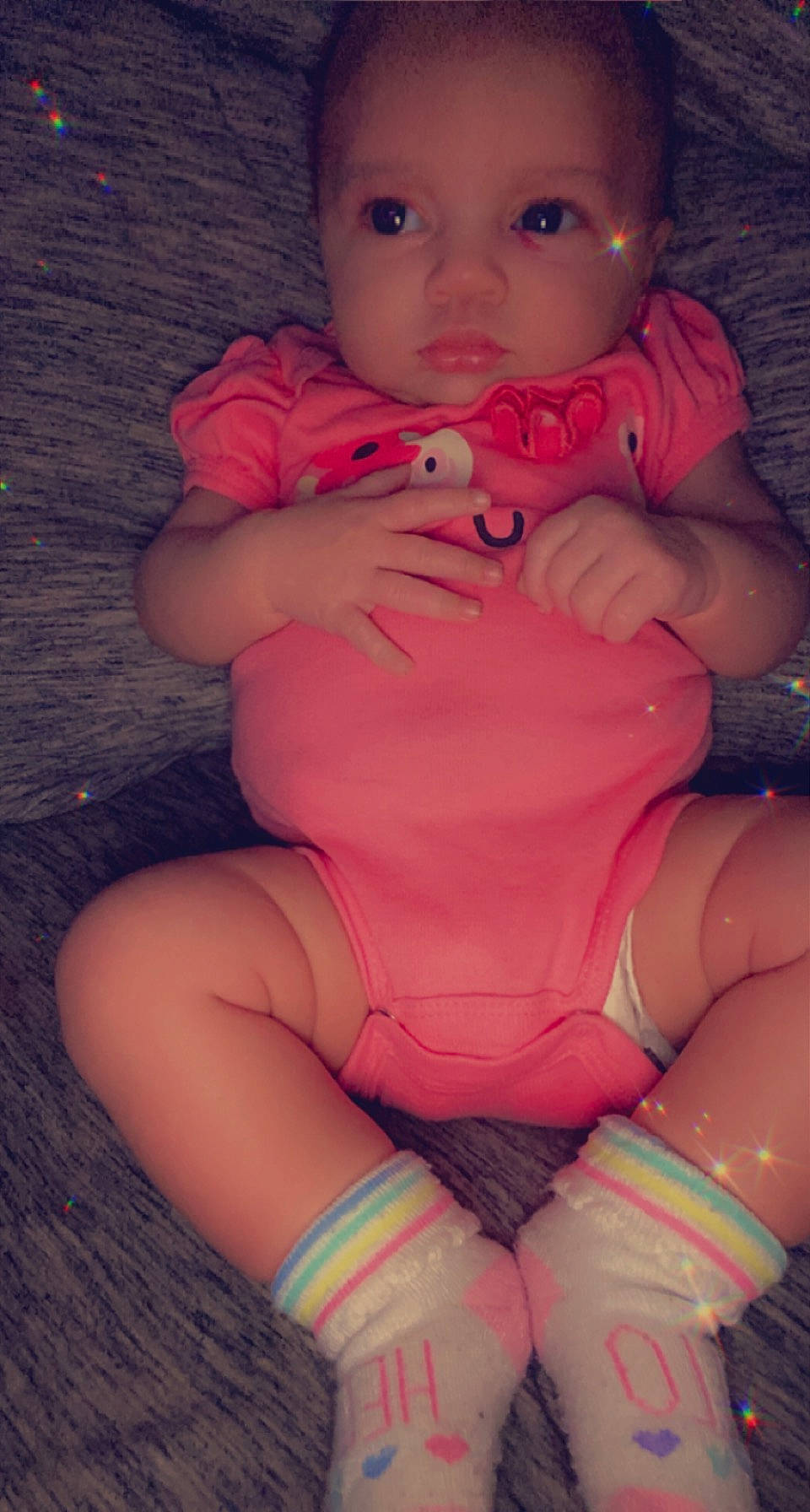 Oaklyn is registered to the contest to win money with this photo: arm, baby, baby_toddler_clothing, cheek, gesture, hand, human_body, joint, leg, lip, mouth, muscle, neck, orange, person, pink, purple, skin, stomach, thigh