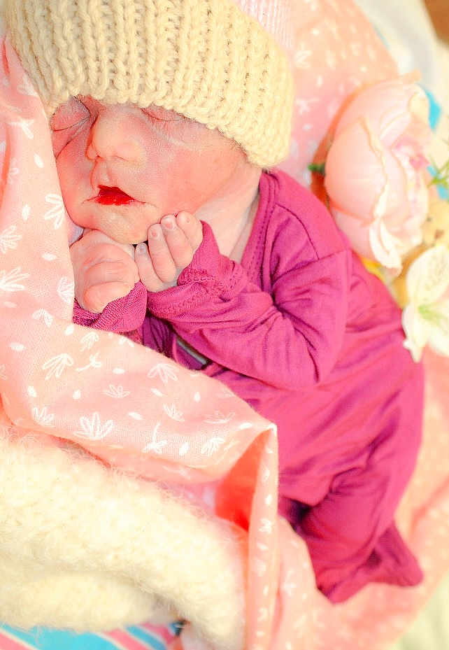 Alara joined the competition — help win amazing prizes! newborn, baby, sleeping, hat, knitted, purple_outfit, blanket, pink, white, flower, soft, cozy, infant, cute, peaceful, resting, child, portrait, indoors, closeup