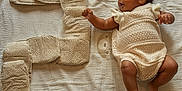 Janelle is registered to the contest to win money with this photo: baby, infant, child, knitwear, blanket, number_five, cushion, soft_texture, lying_down, celebration, cute, skin, expression, hand, foot, indoors, fabric, pattern, comfort, milestone