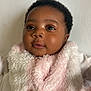 Janelle is registered to the contest to win money with this photo: baby, infant, portrait, close_up, face, curly_hair, blanket, pink, white, soft_texture, smile, eyes, cute, child, skin, warm, cozy, indoors, expression, adorable