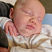 Elowyn Fae is registered to the contest to win money with this photo: baby, sleeping, infant, white_clothing, hand, face, peaceful, cozy, soft_fabric, newborn, child, portrait, indoor, closeup, skin, head, cheeks, person, rest, comfort
