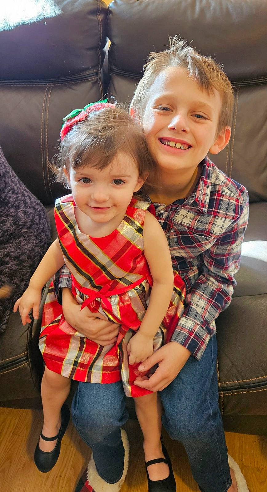 Chloe is registered to the contest to win money with this photo: baby_toddler_clothing, blond, child, event, face, fun, hair, hairstyle, happy, head, interaction, jeans, joy, pattern, person, plaid, red, sitting, skin, smile