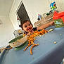 Zouleikha a rejoint le concours — aidez-le/la à gagner de superbes lots ! toddler, child, high_chair, spaghetti, messy, food, sippy_cup, smiling, indoors, table, bowl, face, happy, meal, plastic, kitchen, baby, furniture, clothing, home