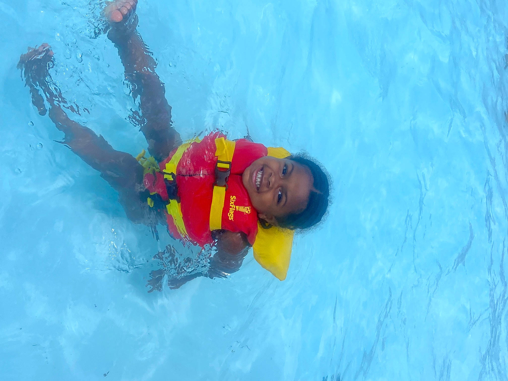 Taeya is registered to the contest to win money with this photo: aqua, azure, child, fluid, fun, happy, individual_sports, inflatable, joy, leisure, leisure_centre, outdoor_recreation, person, personal_protective_equipment, recreation, smile, sports, swimmer, swimming_pool, toddler