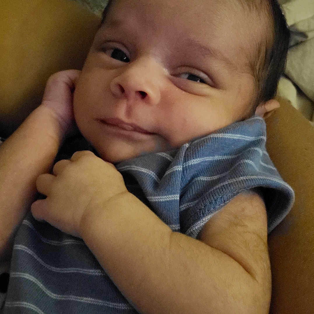 Vincent joined the competition — help win amazing prizes! baby, blanket, child, closeup, comfort, couch, cute, expression, face, hand, indoors, infant, newborn, person, portrait, resting, skin, sleepwear, striped_clothing, young