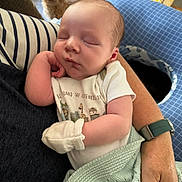 Abel joined the competition — help win amazing prizes! baby, newborn, sleeping, infant, person, arm, dog, puppy, blanket, mitten, clothing, cute, rest, indoor, holding, soft, cozy, watching, pet, relaxation