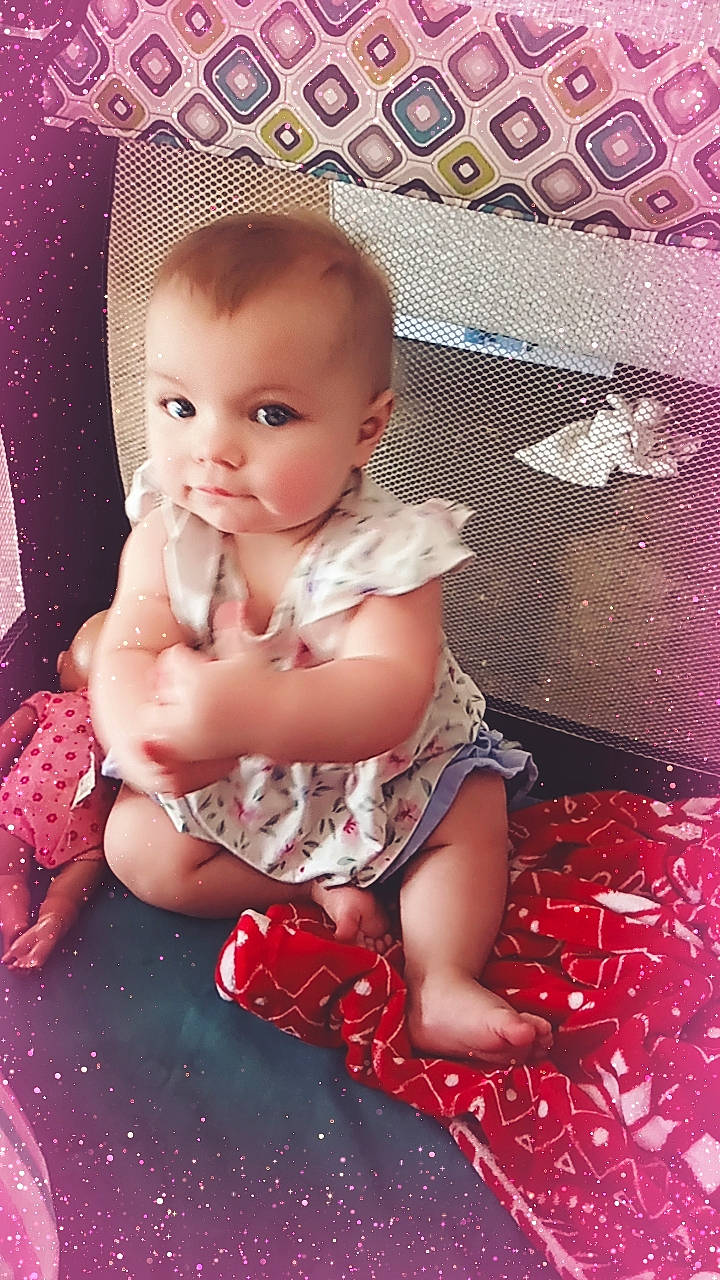 Maggie is registered to the contest to win money with this photo: baby, baby_toddler_clothing, cheek, child, dress, embellishment, event, flash_photography, happy, human_leg, magenta, pattern, person, pink, product, sitting, skin, smile, textile, thigh
