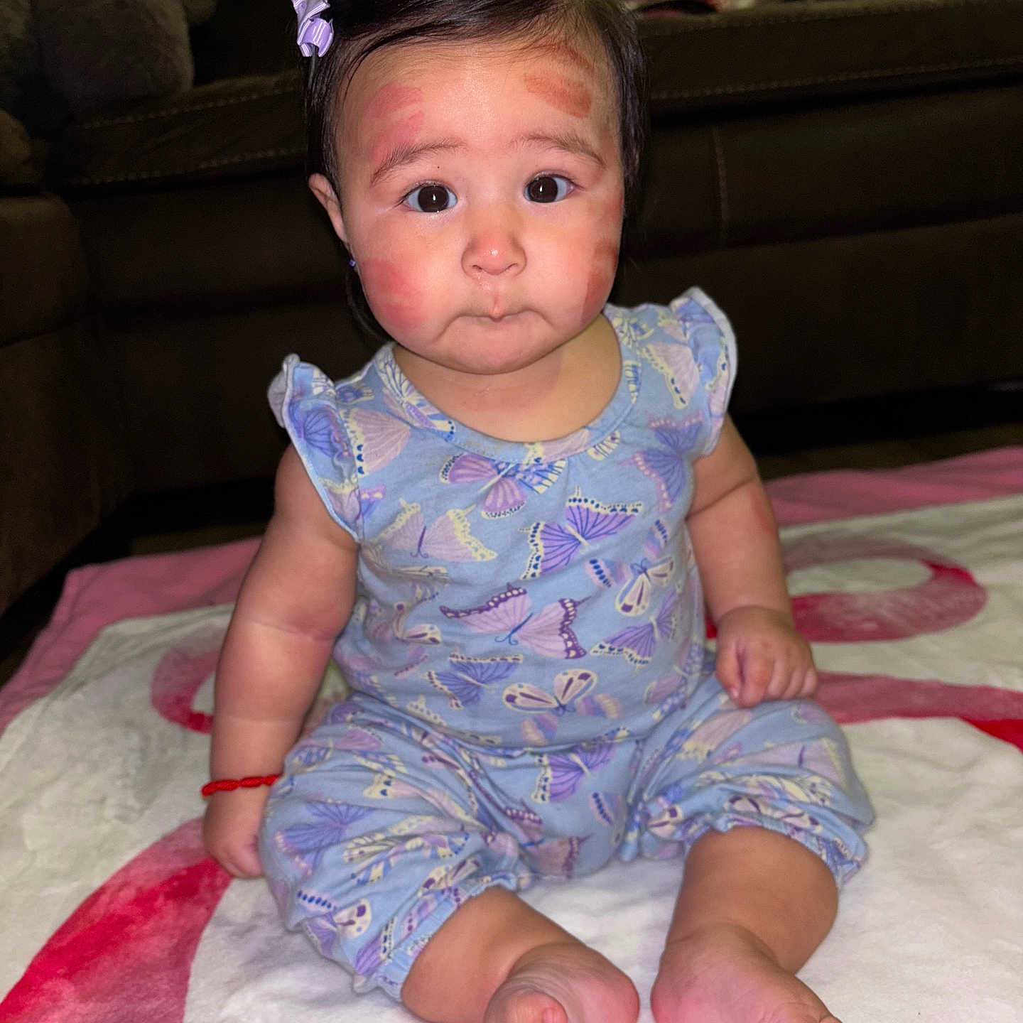 Navani joined the competition — help win amazing prizes! baby, blanket, butterfly_pattern, child, clothing, couch, cozy, curious, cute, expression, face, floor, foot, hair_clip, hand, indoor, person, red_marks, sitting, toddler